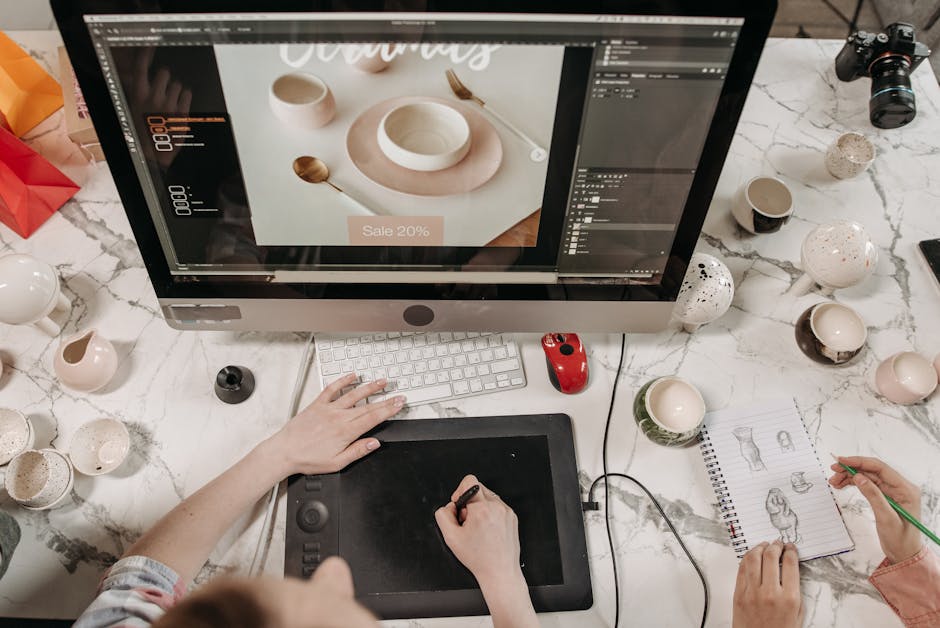 Overhead view of a creative workspace with design tools and sketches visible, ideal for teamwork and collaboration.